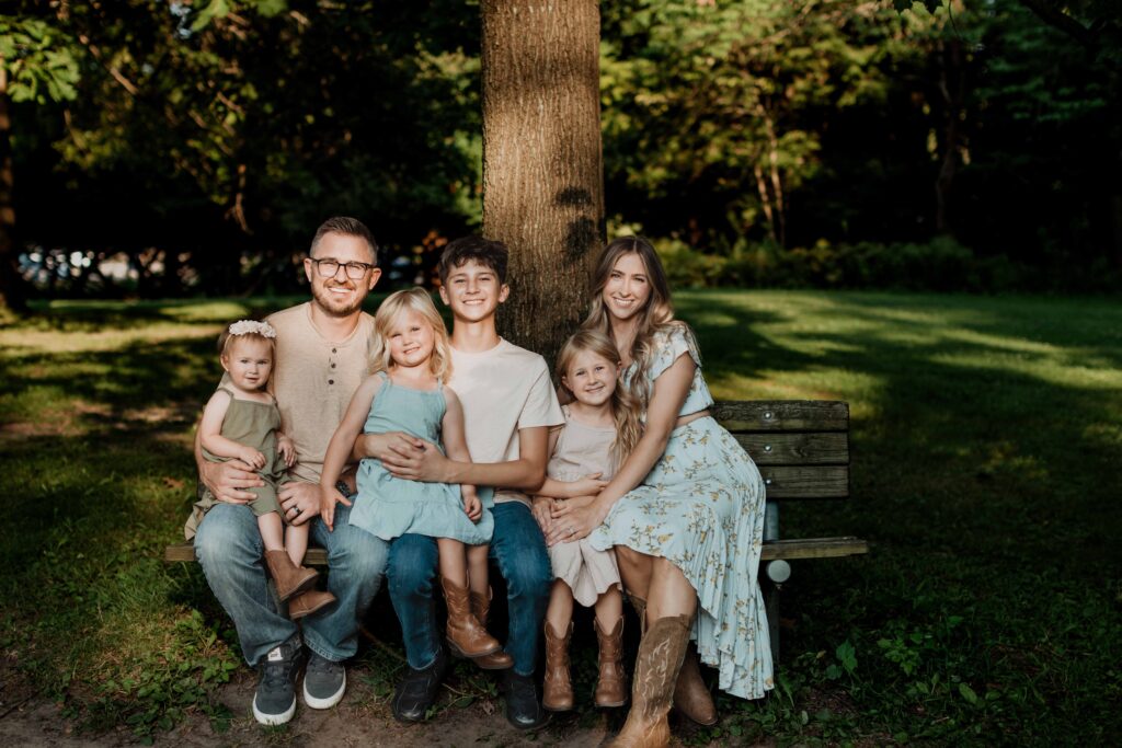 Family photo session at Heritage Park in Farmington Hills — kids playing on the swing surrounded by fall colors, captured by Detroit family photographer Michelle Ann.